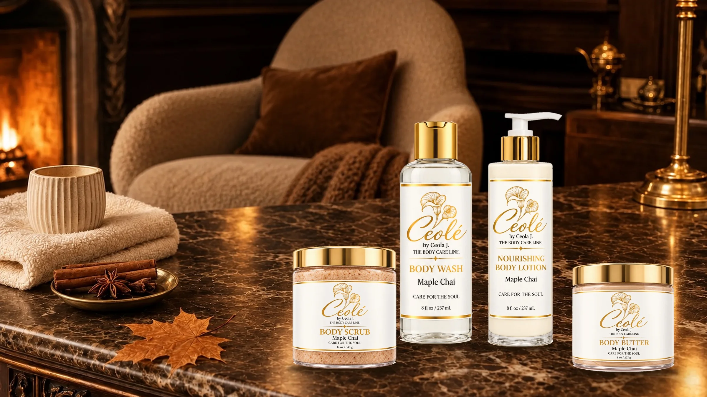 Ceolé Maple Chai body wash, lotion, scrub and butter on a dark marble desk by a fireplace